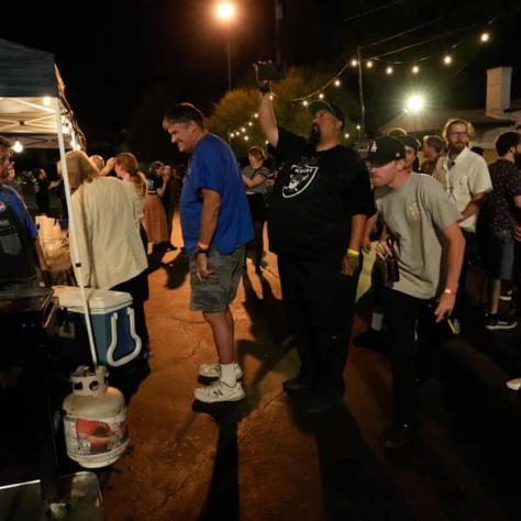 Partygoers getting food at tent. 