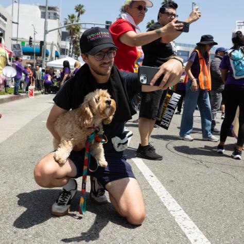 Man with dog at rally.