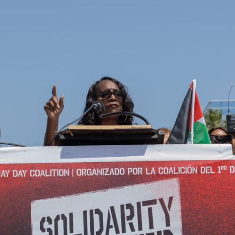 Woman speaking at rally. 