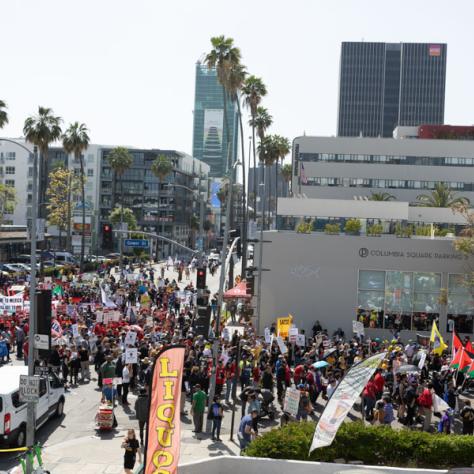 People marching with signs at rally.