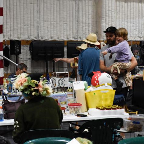 People shopping at yard sale.