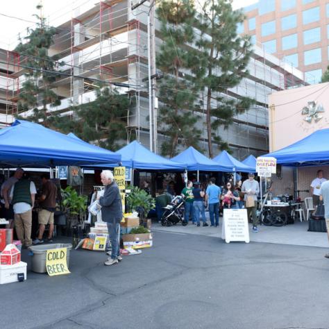 View of tents outside of yard sale. 