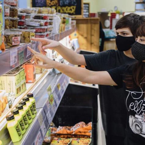 People shopping at a grocery store. 