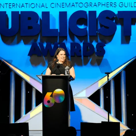 Woman at podium on stage. 