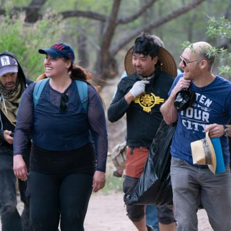 People walking outside on trail. 