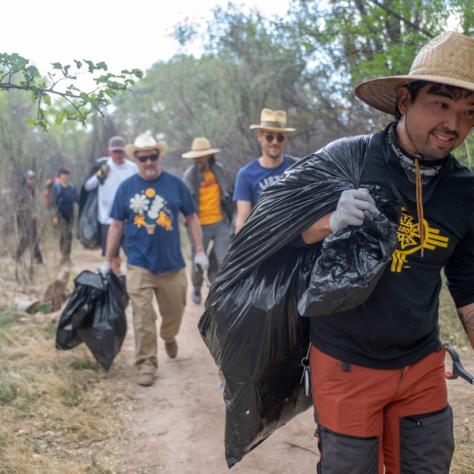 Man holding trash bag. 