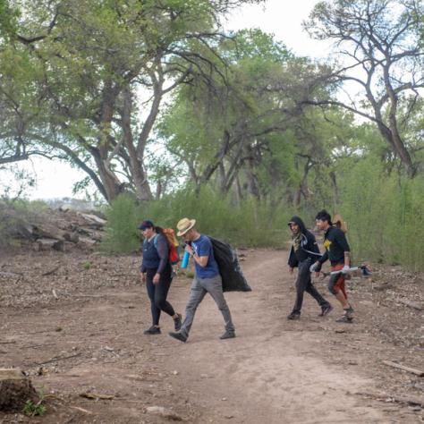 People walking with trash bags. 