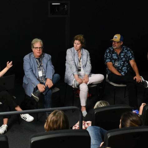 People sitting on stage. 