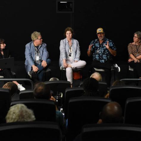 People sitting on stage. 