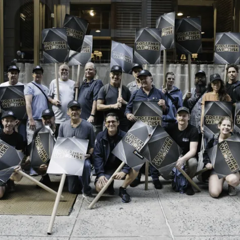 Group photo of people outside with signs. 