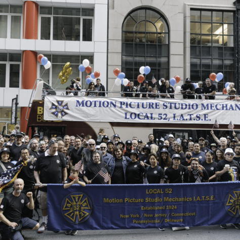 Photo of parade members with banners. 