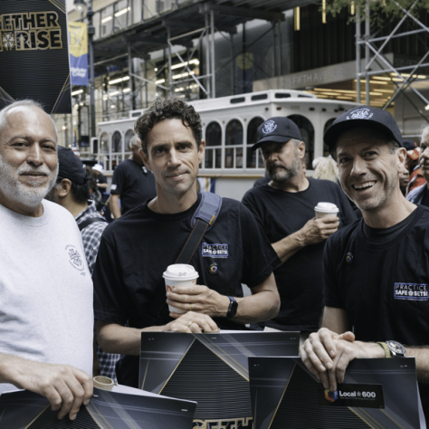 Men posing for a photo at the parade. 