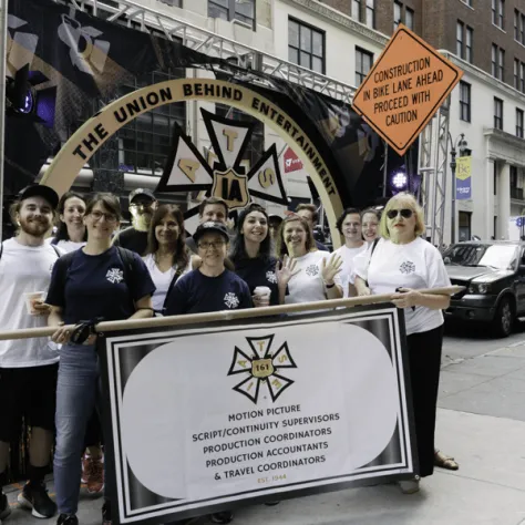 People posing for a photo together in front of a float. 