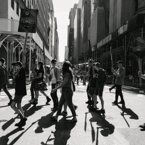 People marching in a parade, black and white photo. 