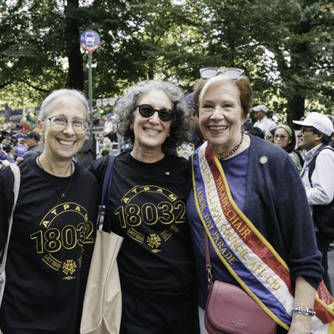 People posing for photo at a parade. 