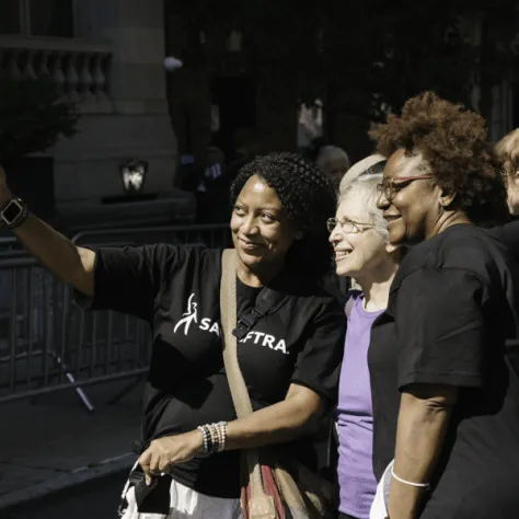 People posing for photo at a parade. 