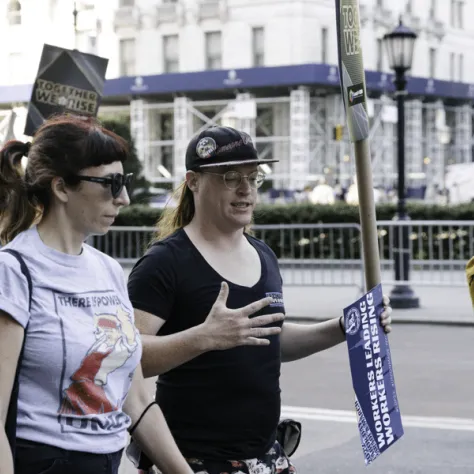 Woman marching in a parade talking. 