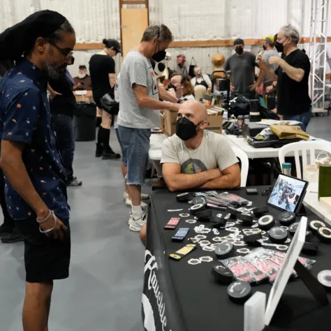 Man looking at yard sale items. 