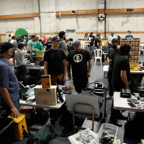 View of people at a yard sale indoors. 