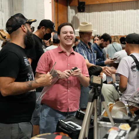 People talking to each other at an indoor yard sale. 