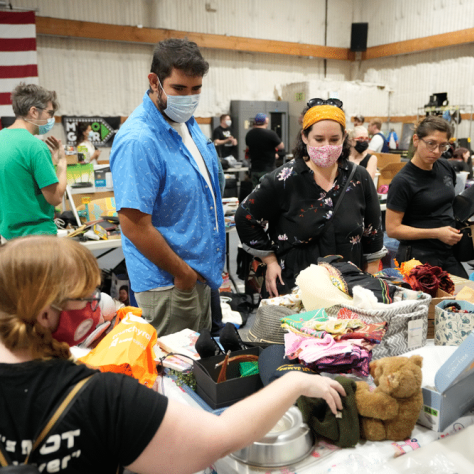 People looking at yard sale items. 