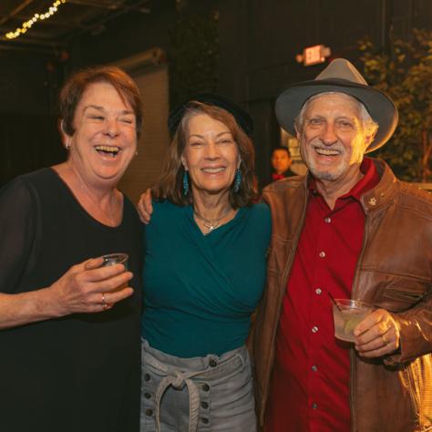 People posing for photo together at party.