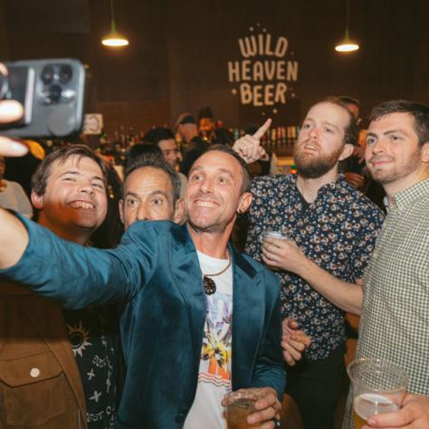 People taking selfie at party. 