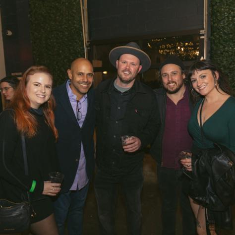 People posing for photo together at party.