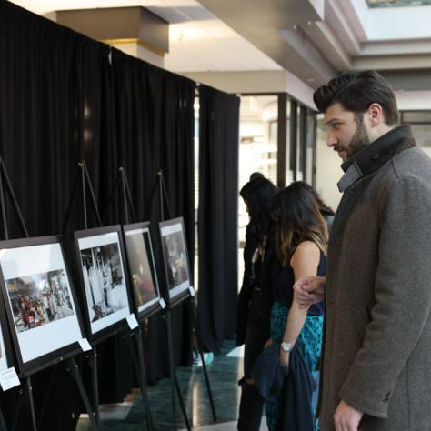 Man looking at photos. 