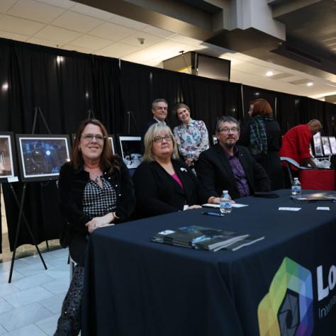 People sitting behind a Local 600 table. 