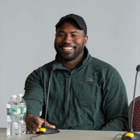 Man smiling at table.