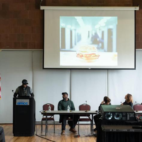 View of podium and panel members. 