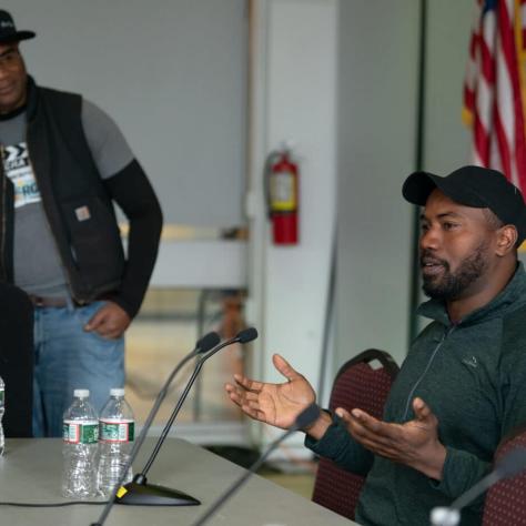 Man speaking at table. 