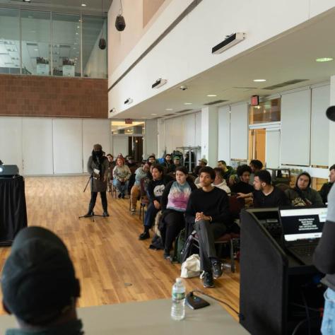 View of audience and panel members. 