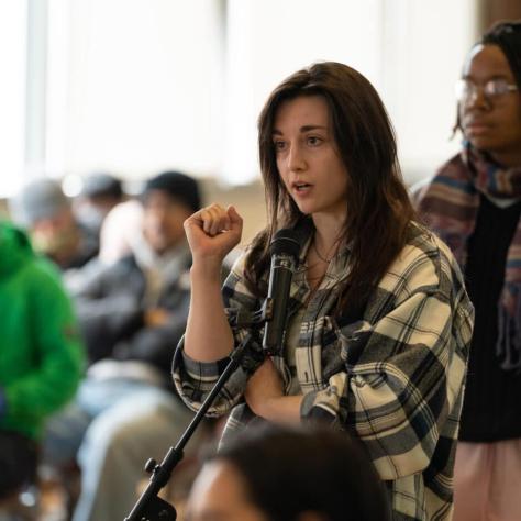 Woman speaking into mic. 