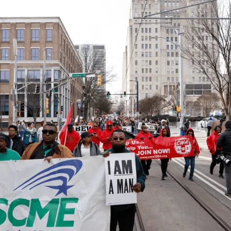 People marching with banners and signs.