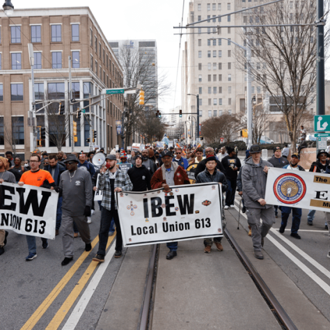 People marching with banners and signs.