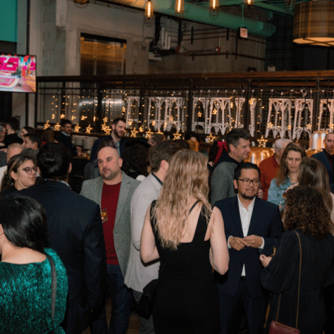 View of venue with partygoers mingling. 