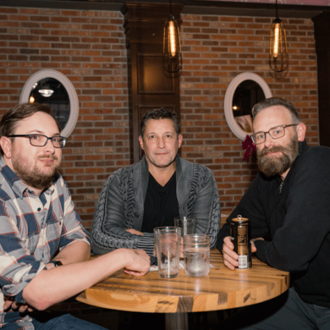 People posing for picture together at a table. 