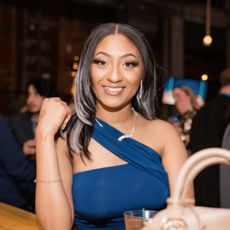 Woman in blue posing for photo.  