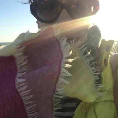 Close up of woman with red and yellow wrap and sunglasses. 