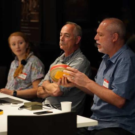 People sitting at a table with film talking. 