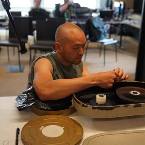 Man sitting working with film. 