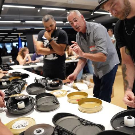 People standing at a table working with film. 