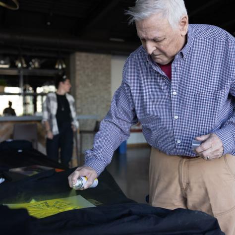 Man decorating shirt. 