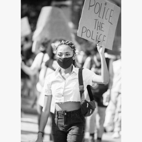 Woman holding sign in the air. 