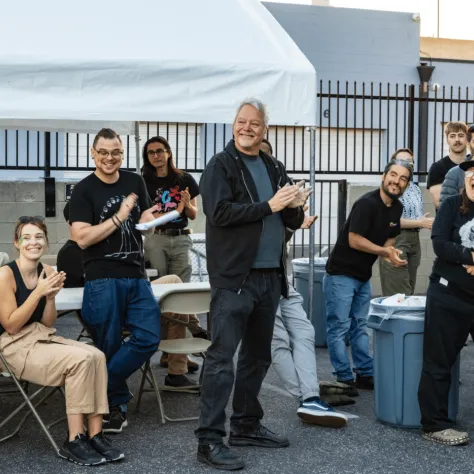 Group of people clapping.