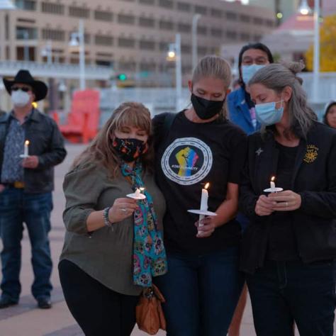 People standing together with candles. 