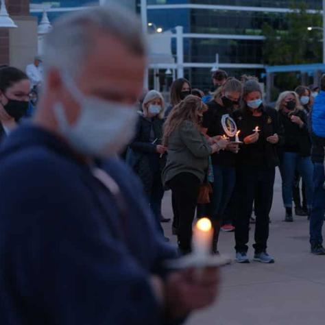 People standing with candles. 