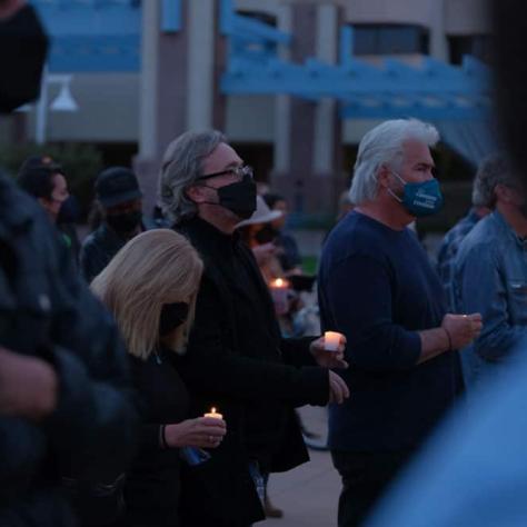 People standing with candles. 